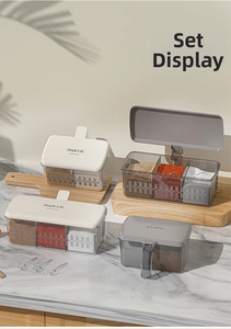 Detail of gray translucent seasoning box set with Simple Life lid on marble surface