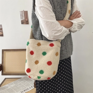 Stylish white lamb wool bucket bag with vibrant colorful polka dots shown on model