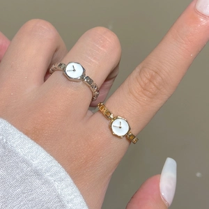 Minimalist watch-shaped rings with hexagonal dials and chain bands on fingers