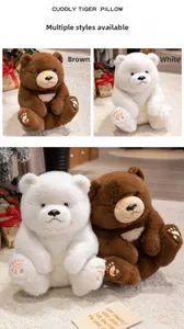 Detail of plush teddy bear soft toy in brown and white variants on cozy home carpet