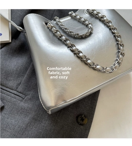 Detail of silver chain bucket bag featuring metallic pleated faux leather texture