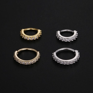 Detail of four-piece set copper nose rings and ear hoops with cubic zirconia pavé