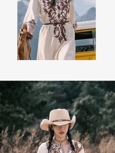 Detail shot of boho-style floral embroidery on the cotton linen dress with a woven belt