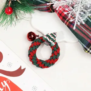 Detailed view of a festive red and green braided Christmas wreath charm with a mini tree