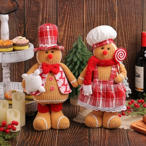 Pair of plush Christmas gingerbread man figurines in warm festive indoor holiday setting