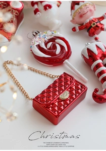 Macro detail of red quilted Christmas mini bag with gold chain and glitter heart charm