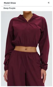 Detail of deep burgundy hooded sun protection jacket with elastic cuffs and zipper