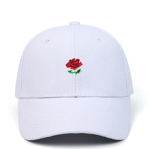 White cotton baseball cap featuring detailed red rose embroidery on a clean white background