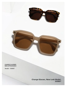 Detail of tortoise shell and beige oversized square sunglasses with gold metal studs