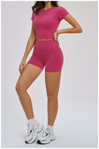 Fuchsia high-stretch yoga set with cropped short sleeve top and high-waisted shorts
