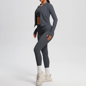 Three-piece charcoal gray yoga set with long sleeve zipper jacket, sports bra and leggings
