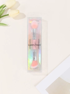 Detailed view of dual-ended pink makeup brush in laser effect packaging with tulips