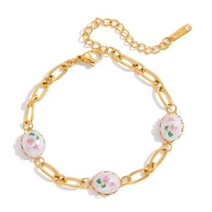 Close-up of gold stainless steel paperclip chain bracelet with pink floral oval charms