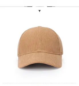 Detailed view of camel corduroy baseball cap with white letter R embroidery and fabric texture