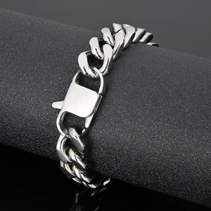 Polished silver titanium steel Cuban link bracelet with large lobster clasp on display