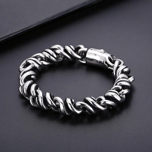 Macro shot of silver heavy twisted rope chain bracelet with snap clasp in stainless steel