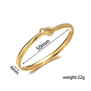 Minimalist gold knotted heart bangle with 6mm width shown from a professional 45-degree angle