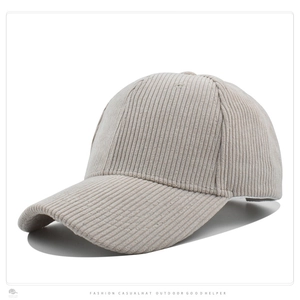 Detailed close-up of a light beige corduroy baseball cap with visible vertical ribbed texture