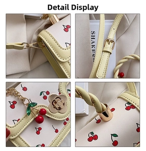 Detail of yellow cherry print bag showing flower buckle and gold twisted handle