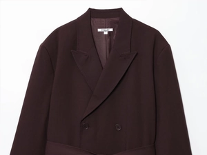 Close-up of dark brown wool coat collar with double-breasted buttons and size S tag