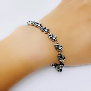 Close-up of vintage silver skull bracelet on wrist showing punk metal craftsmanship