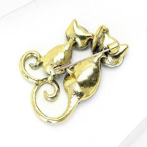 Back view of gold-tone metal twin cat brooch with secure pin clasp and polished finish