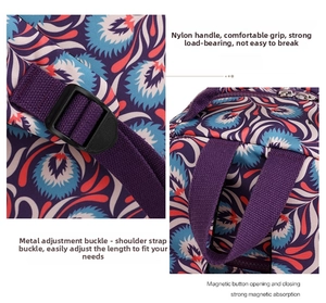 Detail view of nylon floral backpack featuring metal buckles and magnetic snap closure