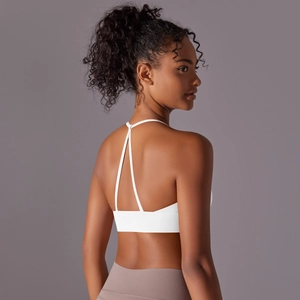 Detailed back view of white halter yoga bra featuring Y-shaped straps and open back design