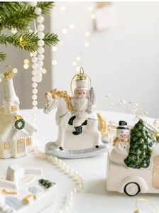 Close-up of white and gold nutcracker on rocking horse and vintage truck Christmas ornaments