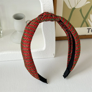 Detail of red and green striped knot headband with glittery metallic wire thread texture