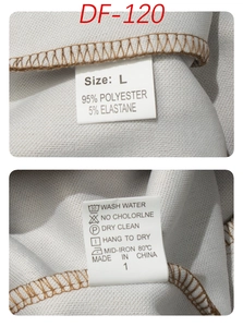 Detail view of garment care label and size L tag on grey pineapple texture shorts