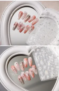 Detailed view of silver butterfly and star 3D embossed nail art stickers on almond nails