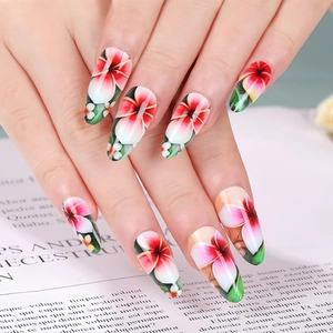 Close-up of almond press-on nails with sweet pink floral and green leaf nail art