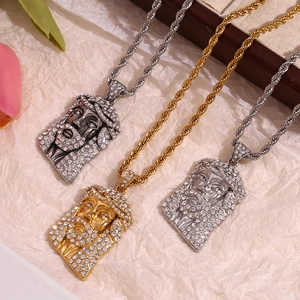 Detailed view of three hip hop Jesus head pendants with rhinestones on twist chains