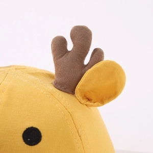 Detailed view of yellow baby hat featuring soft 3D deer horns and fine cotton stitching