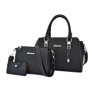 Three-piece black PU leather handbag set with white stitching and gold hardware