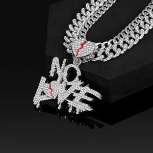 Close-up of NO LOVE letter pendant with red broken heart on iced out Cuban chain