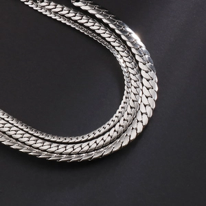 Macro detail of triple layered silver stainless steel flat snake chain bracelets