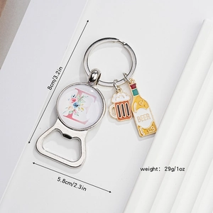 Detailed view of beer opener keychain with letter E floral charm and beer bottle pendant