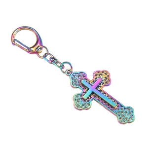 Rainbow alloy cross keychain with hammered texture and lobster clasp on white background
