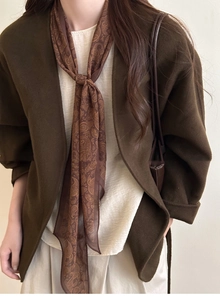 Detail shot of vintage brown paisley silk scarf necklace with ethnic patterns for women
