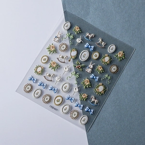 Detail view of 5D embossed nail stickers featuring vintage rabbits and floral designs