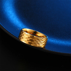 Detailed close-up of 8mm golden titanium steel ring with textured hammered finish