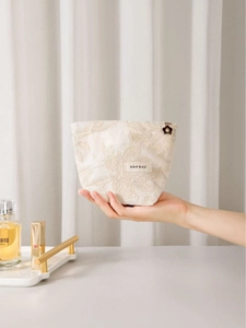 Pochette en lin avec broderie florale et fermeture éclair dorée en forme de fleur