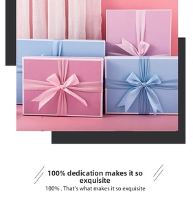 Detail of pink and sky blue gift boxes with elegant satin bows for perfume or jewelry