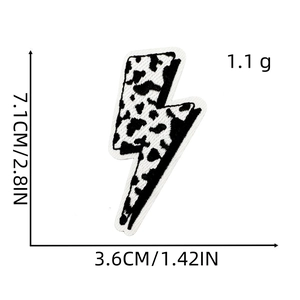 Detail of lightning bolt embroidery patch with black and white cow print, 7.1x3.6cm size