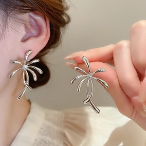 Silver palm leaf earrings with central crystal detail shown as worn and held macro view