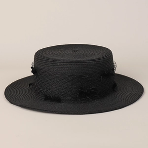 Detail of black boater hat featuring elegant mesh veil and decorative small bows