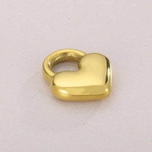 Close-up of polished gold heart-shaped hollow pendant made of stainless steel