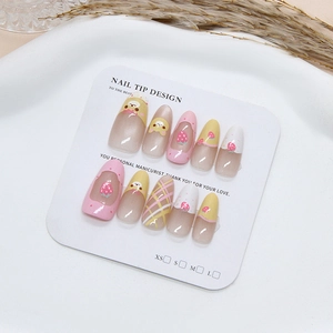 Handmade almond nails with cute bear, strawberry motifs, and yellow grid patterns